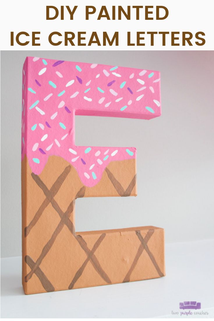 the letter e is made out of cardboard and has sprinkles on it