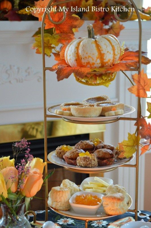 three tiered trays filled with pastries and desserts on top of a table