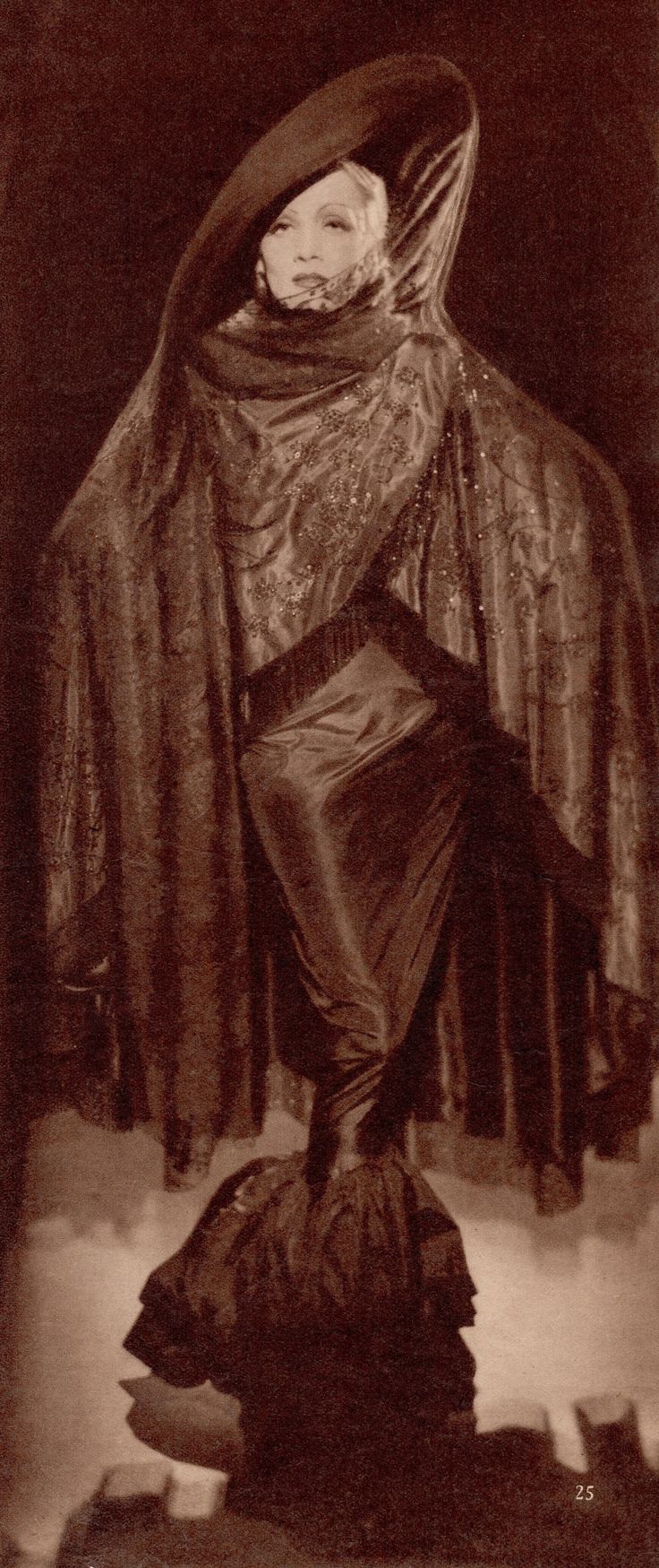 a black and white photo of a woman dressed in costume