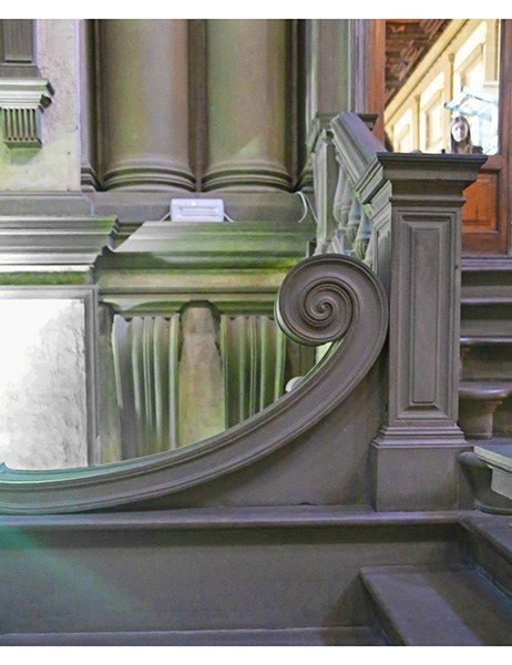 the reflection of an ornate staircase in a mirror