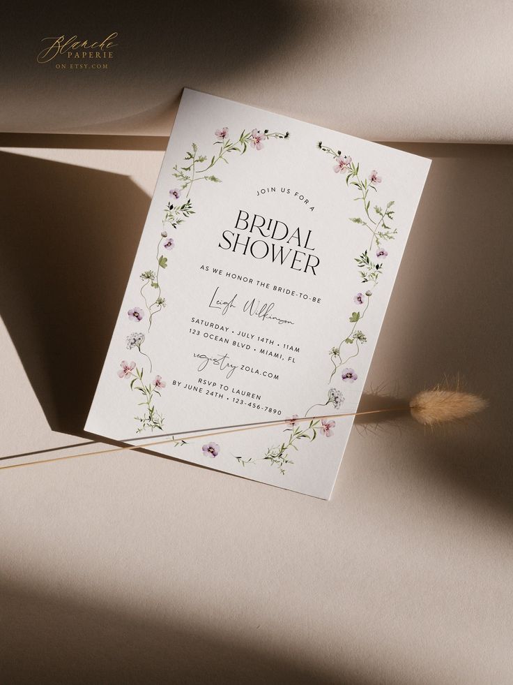 an elegant floral bridal shower card on a table