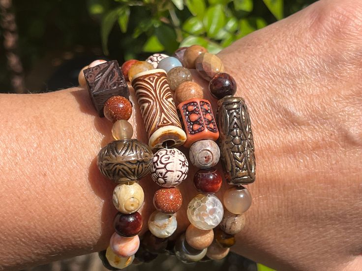 This bracelet is a gorgeous combination of various types of gemstones and other mixed beads that make it a truly unique and one of a kind piece!! Each bracelet is a pretty mix of gemstone beads like agate, jasper, tigers eye and onyx (to name a few). Each combines beautiful vintage, textured acrylic beads, wooden and glass beads  and are perfect and versatile to wear with so much! Casual or elegant alike!! Stainless steel memory wire. Sterling silver head pins. One size fits most. Luxury Handmade Brown Jewelry, Luxury Brown Gemstone Beads Jewelry, Bohemian Agate Beaded Bracelets, Bohemian Stretch Bracelet With Colorful Beads For Meditation, Bohemian Bead Bracelet For Meditation, Handmade Wrap Bracelet With Round Beads For Healing, Bohemian Bracelets With Colorful Agate Beads, Bohemian Agate Bracelets With Colorful Beads, Brown Gemstone Beads Wrap Bracelet Gift