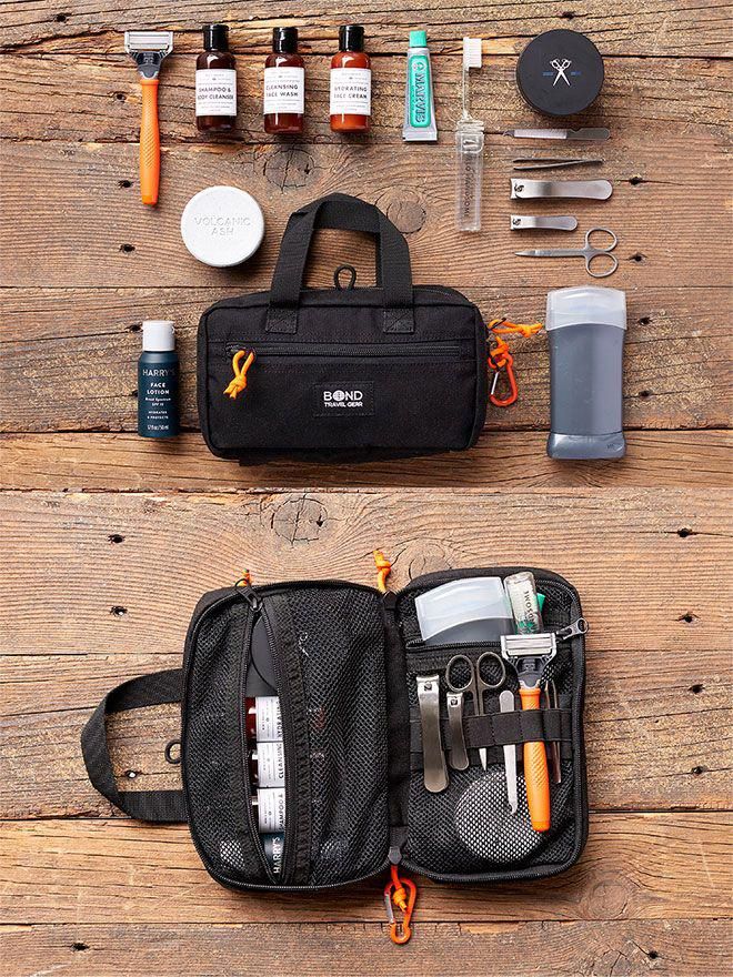 the contents of a travel bag laid out on top of a wooden table next to scissors and other items