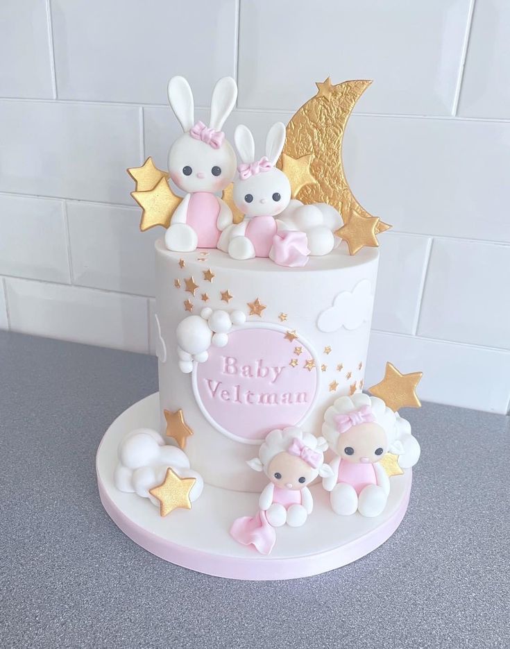 a white cake with pink and gold decorations