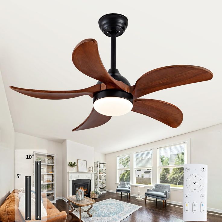 a ceiling fan in the middle of a living room with hardwood floors and white walls