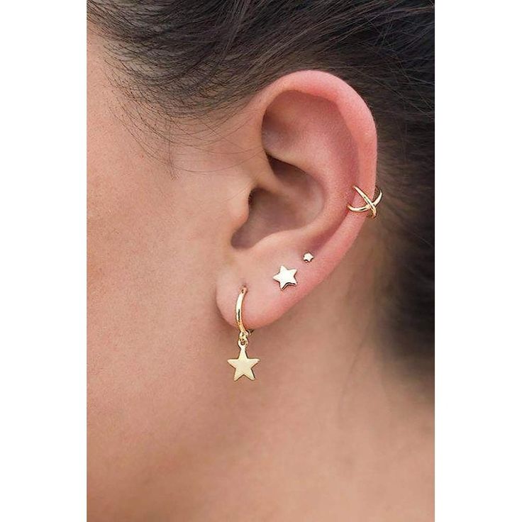 a close up of a person's ear with two stars on the side of it