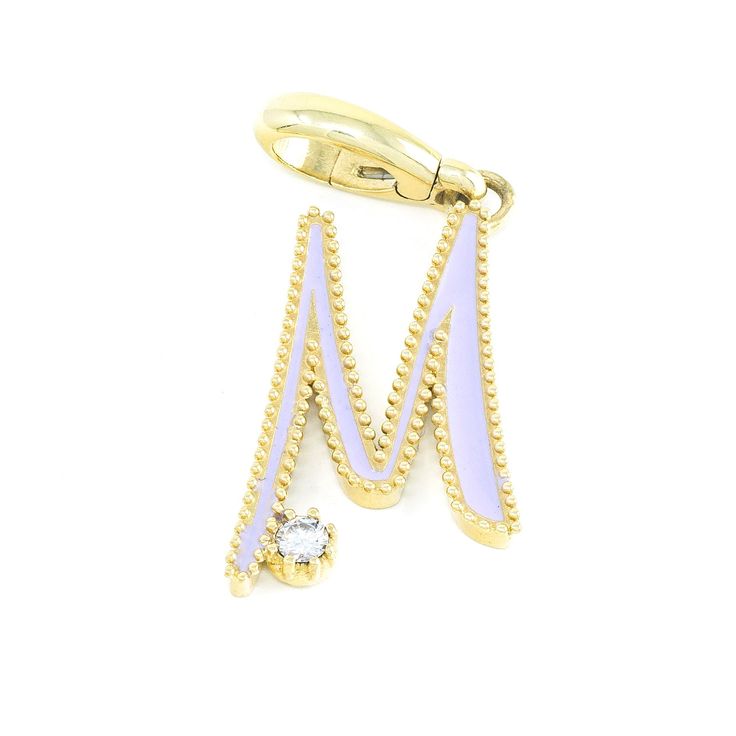 a pair of yellow gold and white enamel ear clips with crystal stones on each end