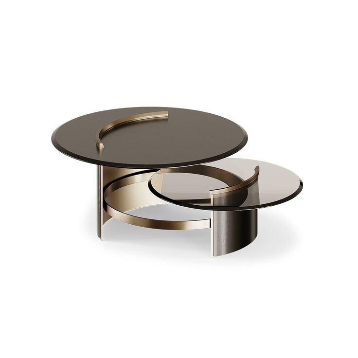 two tables with circular glass tops and metal bases, one is black and the other is gold