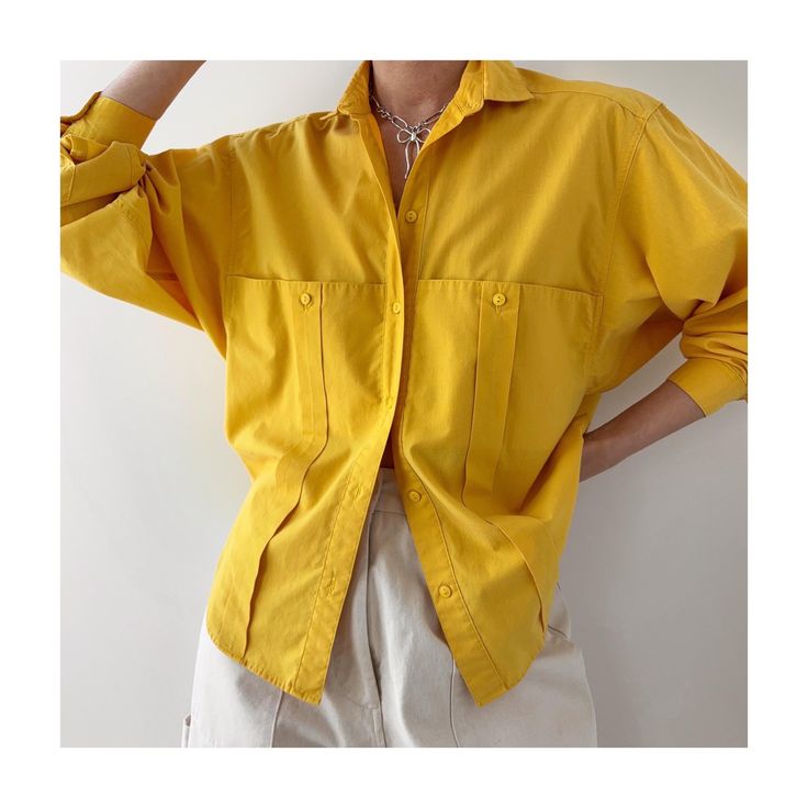 Vintage 80s relaxed fit golden yellow button down shirt.  Unique pockets.  Slouchy fit with baggy long sleeves.  Circa 80s 90s.  55% cotton 45% polyester.  Bright golden yellow color.  Brand: Lady Manhattan  In great condition.  Labeled as size 10. Also fits smaller sizes more oversized.  I'm XS/S 5'7 wearing it in the photos. 〰️Measurements taken flat: Armpit to armpit - 20" Length(back collar seam to hem)- 25.5" (shorter on the sides) Shoulder to shoulder seam - 18" Sleeve length(from mid coll Vintage Oversized Shirt With Pockets, Oversized Yellow Long Sleeve Top, Spring Yellow Tops With Pockets, Yellow Workwear Tops With Pockets, Yellow Tops With Pockets For Fall, Yellow Fall Tops With Pockets, Yellow Casual Solid Color Shirt, Casual Solid Yellow Shirt, Oversized Yellow Tops With Pockets