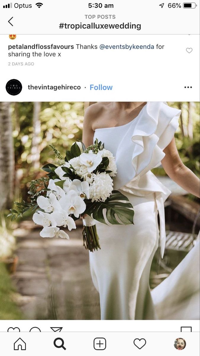 a woman in a white dress holding a bouquet of flowers on her wedding day, instagram