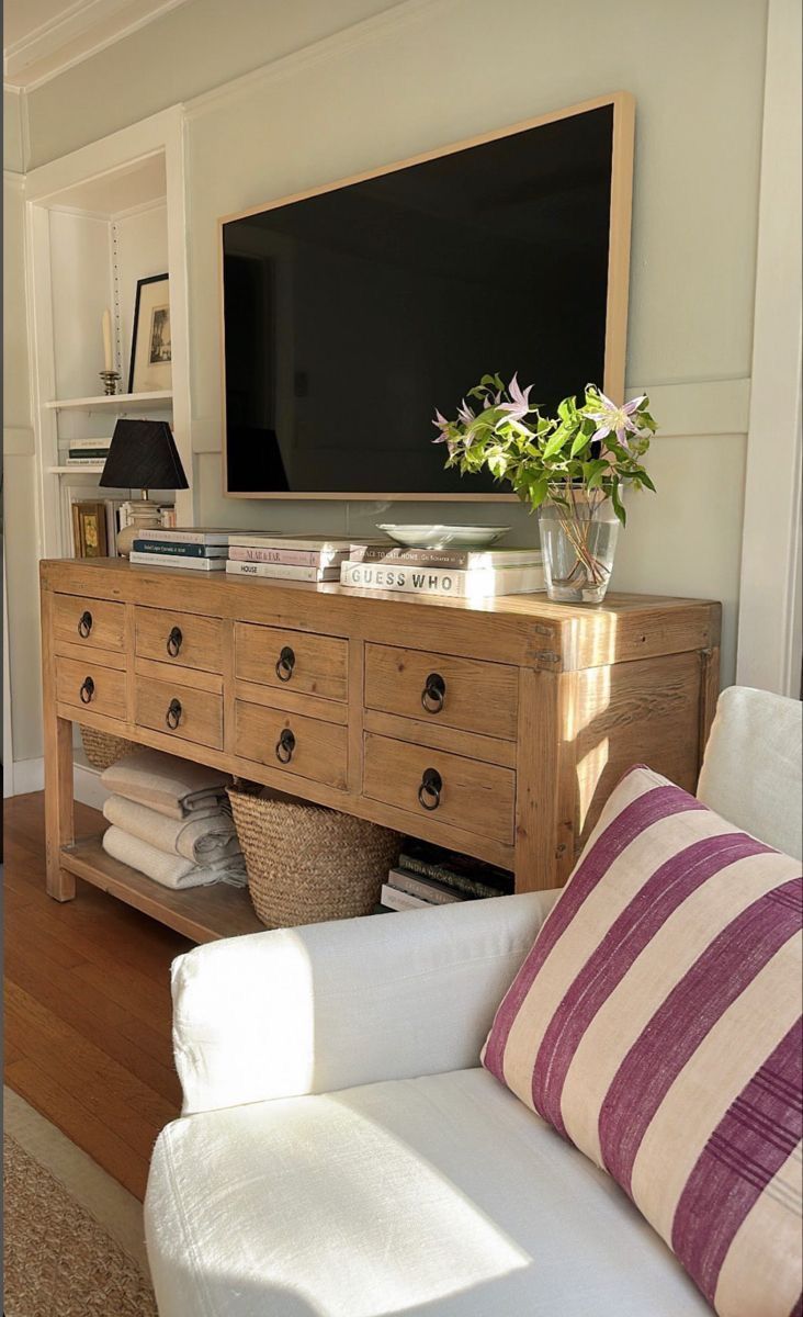 a living room scene with focus on the entertainment center and sofa in the foreground