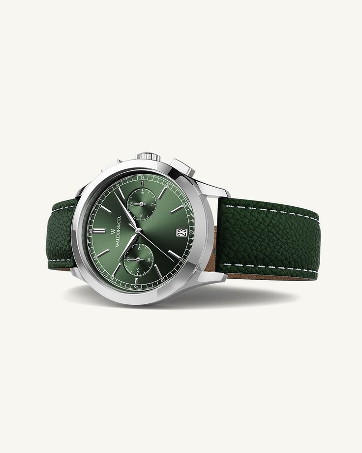 Case diameter: 39 mmCase thickness: 11.15 mmMaterial: Rhodium-plated 316L stainless steel Dial: Green sunray dial in brassIndex & hands: Polished stainless steelGlass: Sapphire CrystalMovement: Seiko VK64 HybridWater Resistance: 10 ATM (snorkeling)Strap: Genuine green leather, clasp in rhodium-plated stainless steelStrap size: Onesize, fits all wristsLug width: 20 mmPackaging: Black leather box with certificate and manualAvailability: In stock, Free and fast Shipping Worldwide Green Watch, Timeless Watches, Leather Box, Ring Watch, Silver Gifts, Green Leather, Watch Brands, Bracelet Gift, Leather Watch