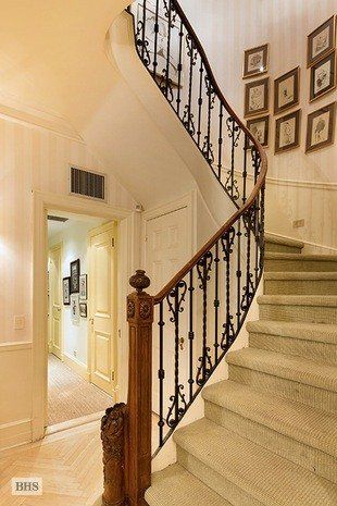 a staircase in a house with pictures on the wall