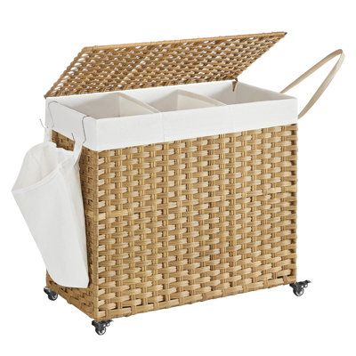 a wicker storage basket with wheels and white liners on the bottom is shown in front of a white background