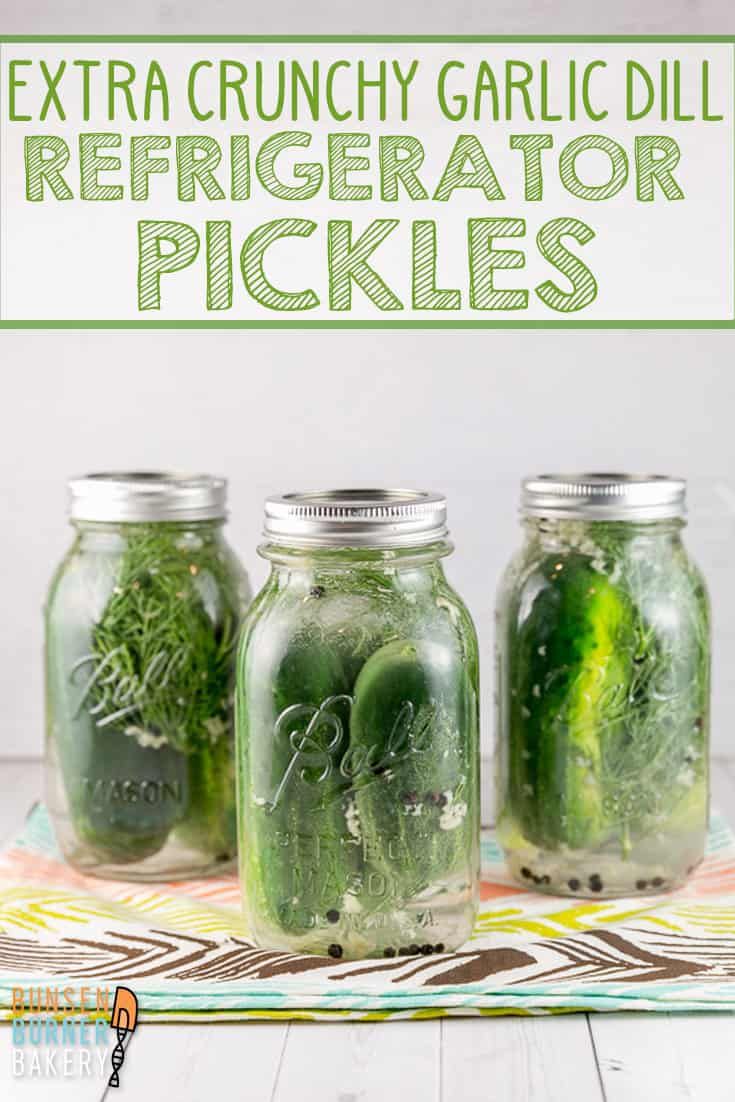 three jars filled with pickles sitting on top of a table