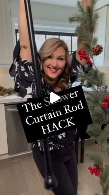 a woman holding up a sign that says, the power curtain rod hack is in front of her