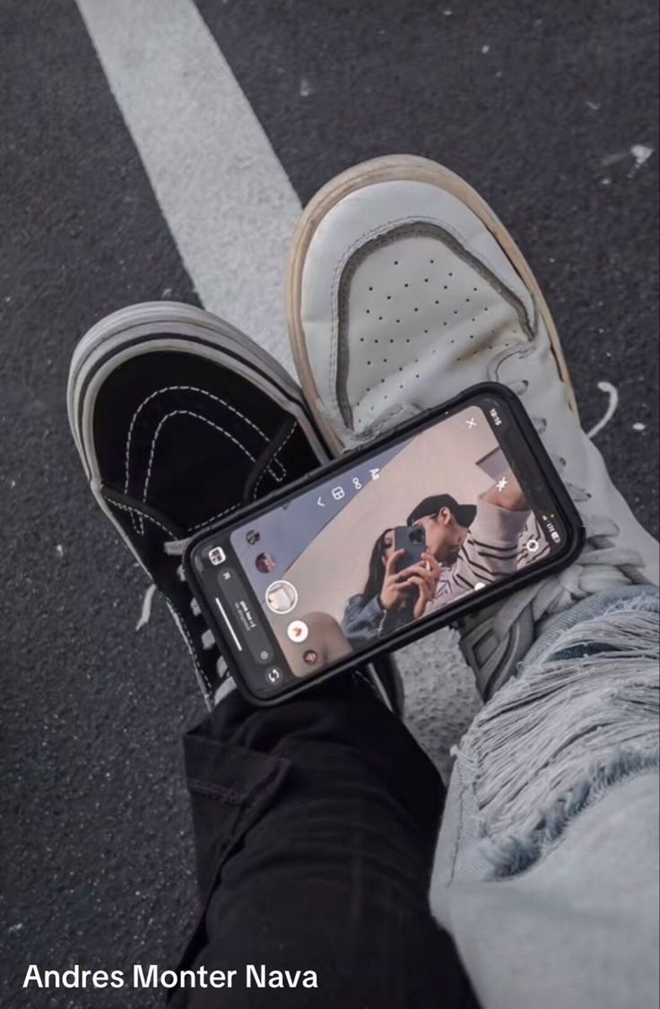 someone is taking a selfie with their cell phone in the middle of the street