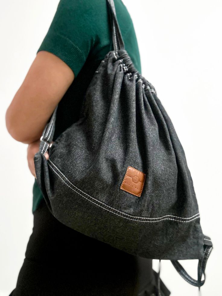 ❇️A lightweight mini black backpack purse could be the best every day carry bag. This cute  frayed denim drawstring bag has an inside pocket to keep your small personal items. On the back side of this stylish bag strap, there is a short handle, making it convenient to carry in the hands when necessary. Drawstrings of the small backpack are adjustable.  ❇️This canvas backpack is comfortable and  soft to touch to the body. Although minimalist, this stylish backpack accommodates the most necessary things. It is a great companion for everyday walks or holidays when you want to carry as little weight as possible. It is also suitable for carrying minimal sports, yoga, or other gear when heading to exercise.  ❇️Packaged in a box.  It can be a fashion practical travel gift ❇️Material: Made from st Trendy Travel Drawstring Bag, Trendy Drawstring Bags For Everyday Use, Trendy Everyday Bags With Drawstring, Casual School Backpack With Drawstring, Casual Backpack With Drawstring For Daily Use, Casual Large Capacity Drawstring Bag, Everyday Large Capacity Drawstring Backpack, Casual Backpack For Back To School, Casual Large Capacity Drawstring Bag For Everyday