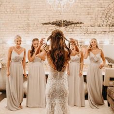 the bridesmaids are getting ready for their wedding at the brick wall in the background