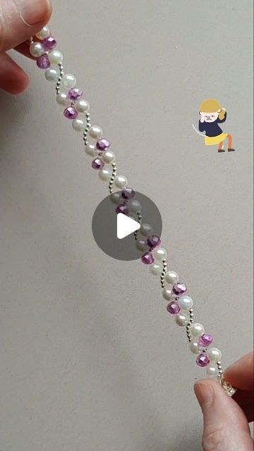 someone is making a beaded bracelet with pearls and purple beads on the end of it