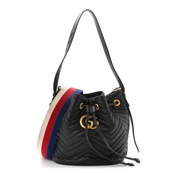 This is an authentic GUCCI Calfskin Matelasse Sylvie Web GG Marmont Bucket Bag in Black. This structured bucket bag is crafted of soft calfskin leather in black with a beautifully stitched chevron pattern. It features an adjustable leather shoulder strap, an optional striped canvas strap, a top cinch cord and an aged gold GG logo. On the back of this beautifully crafted bag, there is a heart stitched design. This bag opens to a rose beige microfiberinterior with patch pockets. Gucci Bucket Bag With Adjustable Strap, Designer Gucci Bucket Bag For Evening, Gucci Bucket Bag With Leather Handles, Designer Gucci Bucket Bag With Removable Pouch, Gucci Luxury Bucket Bag For Daily Use, Daily Use Gucci Luxury Bucket Bag, Daily Use Luxury Gucci Bucket Bag, Gucci Leather Bucket Bag, Chic Gucci Bucket Bag With Removable Pouch