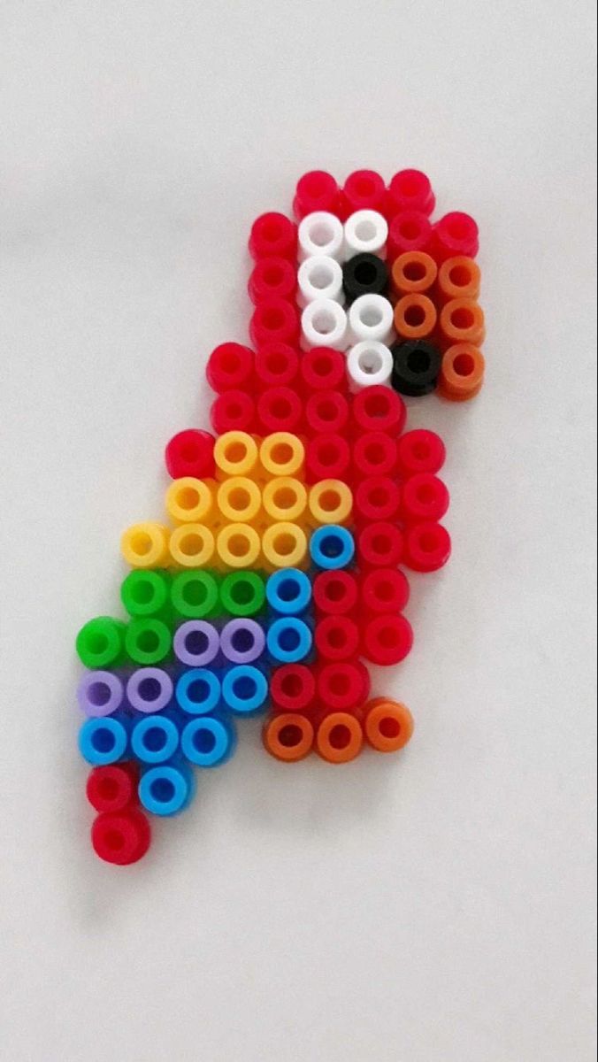 a toy made out of legos sitting on top of a white table next to scissors