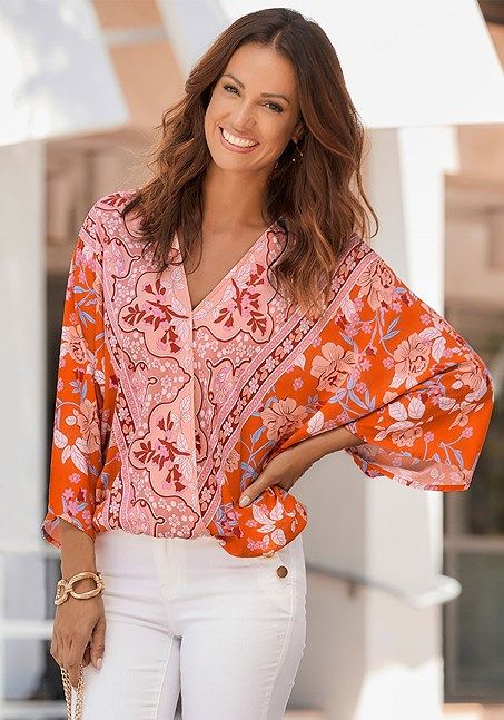 This bold floral print blouse offers an exciting and stylish way to express yourself and stand out from the crowd! Flowy V-neck Blouse With Floral Print, Patterned Floral Print V-neck Top, Trendy V-neck Floral Print Blouse, Trendy V-neck Blouse With Vibrant Print, Spring Bold Print Orange Tops, Long Sleeve Floral Print Blouse For Summer, Summer Floral Print Patterned Blouse, Spring Floral Print V-neck Blouse, Spring Beach Blouse With Abstract Print