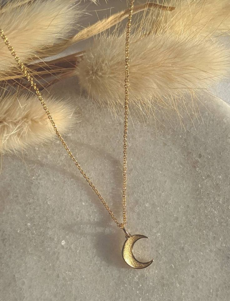 "Beautiful dainty crescent moon necklace, a simple gold pendant on a 16\" or 18\" fine trace chain gold filled. Pendant measures 1cm  Please be sure to enter length at checkout.  Comes with a small gift box and polishing cloth. This is the perfect necklace to layer up. All UK orders are sent via the Royal Mail 1st Class Signed for service. All international orders are sent via a Tracked and Signed service where possible. SHOP MORE STYLES: Honeyandember.etsy.com/ FIND ME ON: www.instagram.com/hon Simple Gold Pendant, Moon Necklace Gold, Crescent Moon Necklace Gold, Gold Moon Necklace, Gold Headband, Crescent Moon Necklace, Gold Moon, Small Gift Boxes, Gold Halo