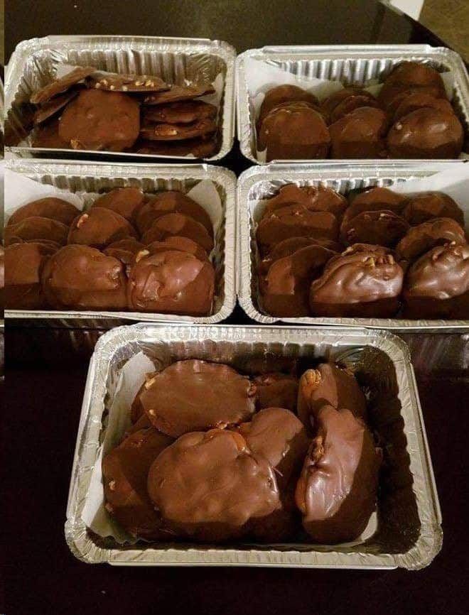 four pans filled with chocolate covered cookies on top of a table