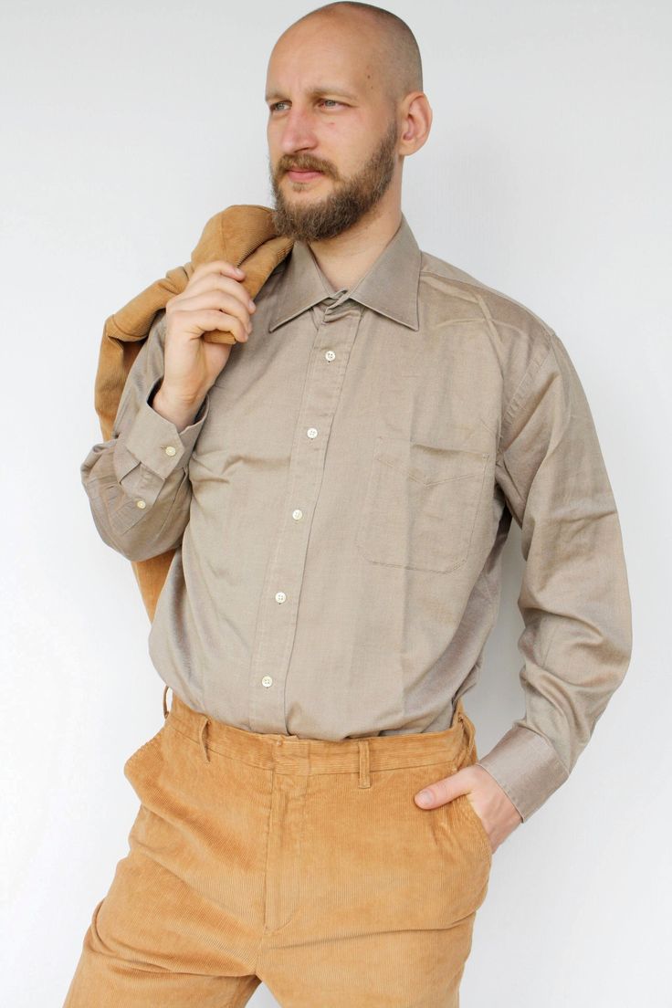 "Brown button up men's shirt Vintage cotton plus size casual formal dress shirt with chest pocket High quality long sleeved cotton shirt, has one chest pocket. Will look great with anything, especially in formal events. In great vintage condition. Measured laying flat - double for circumference: From armpit to armpit: 26\" (66 cm) Length: 33.5\" (85 cm )   Sleeve length: 24\" (61 cm) Tag: Daniel Cremieux, France Model in the photos is size L More from Vintage Finds: https://www.etsy.com/shop/som Classic Beige Shirt With Welt Pockets, Semi-formal Shirt With Spread Collar And Pockets, Collared Business Shirt With Pockets, Business Button-up Shirt With Pockets, Formal Shirt With Pockets And Lapel Collar, Office Wear Button-up Shirt With Pockets, Classic Semi-formal Shirt With Pockets, Formal Shirt With Spread Collar And Pockets, Long Sleeve Dress Shirt With Pockets For Work