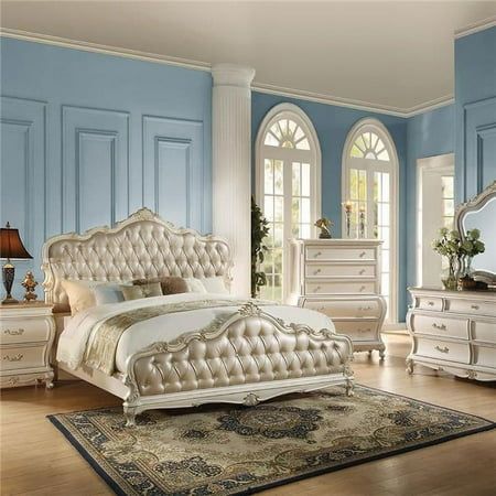 a bedroom with blue walls and white furniture