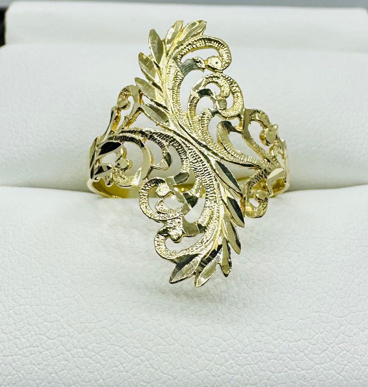 This 10 karat Yellow Gold ring weighs 1.90 grams in total weight. Leaf decorations on the ring are diamond cut, making it the perfect amount of shiny. The statement piece of the ring measures 23 mm in length and 10.88 mm in width. Ring is a size 7 3/4 and stamped with "10K". All items arrive wrapped carefully for shipping and in a gift box. Leaf Decor, Yellow Gold Ring, Ring Size 7, Diamond Cut, Yellow Gold Rings, Rings Statement, Gold Ring, Statement Rings, Gold Diamond