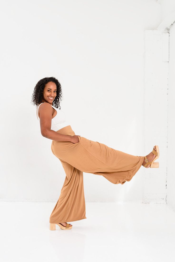 Slip into buttery-soft comfort with sophisticated style in our Vietnam Wide Leg Tie Bottom Pant. Crafted from eco-friendly bamboo fabric, the same luxurious material as our Everyday Travel Wrap, these pants are breathable, anti-bacterial, and odor-resistant, offering a fresh feel all day long. Designed for ultimate versatility, you can wear these pants in a flowing wide-leg silhouette, cinch them slightly for a more tailored look, or tie them all the way for a chic genie pant style. Perfect for Wide Leg 4-way Stretch Yoga Pants For Loungewear, Wide Leg Yoga Pants With 4-way Stretch For Loungewear, Versatile Summer Loungewear Yoga Pants, Wide Leg Pants With Tie Waist For Loungewear, Summer Loungewear Yoga Pants, Loungewear Wide Leg Pants With Tie Waist, Chic Wide-leg Yoga Pants, Versatile Summer Yoga Pants For Loungewear, Versatile Solid Color Yoga Pants For Summer