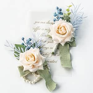 two boutonnieres with flowers on them sitting next to an old piece of paper