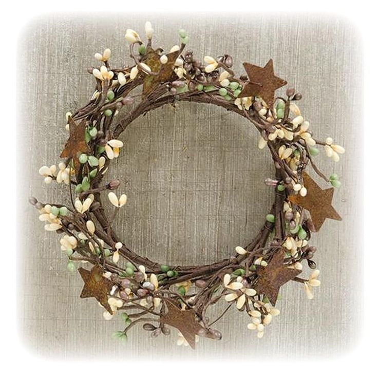 a wreath with leaves and flowers on it