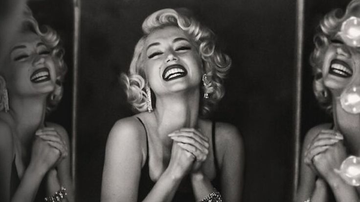 marilyn monroe laughing in front of two mirrors