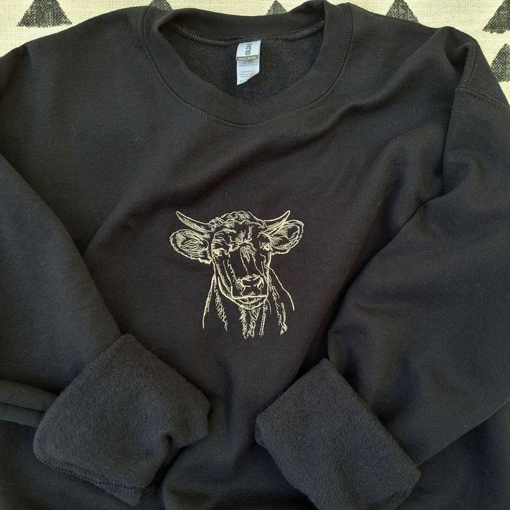 Cow Embroidered Sweatshirt Listed Photo is a Black Sweatshirt with Beige (843) Thread * The design is a set size, it can appear larger or smaller depending on the size of the sweatshirt *Sweatshirt 50/50 pre-shrunk cotton/polyester Reduced pilling and softer air-jet spun yarn 1x1 athletic rib knit collar, cuffs, and waistband, with spandex Double-needle stitched cuffs and waistband Safety Green is compliant with ANSI/ISEA 107 High Visibility standards Tearaway Label *Design Stitched with embroid Relaxed Fit Fleece Sweater With Crew Neck, Black Embroidered Long Sleeve Sweater, Black Long Sleeve Embroidered Sweater, Oversized Winter Sweater With Embroidered Logo, Winter Crew Neck Sweatshirt, Black Cotton Sweater With Embroidered Logo, Oversized Black Sweater With Embroidered Logo, Winter Black Embroidered Tops, Crew Sweatshirt With Embroidered Logo For Winter