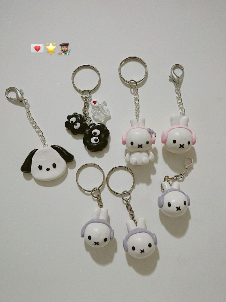 several keychains with cartoon characters on them sitting next to each other in front of a white background