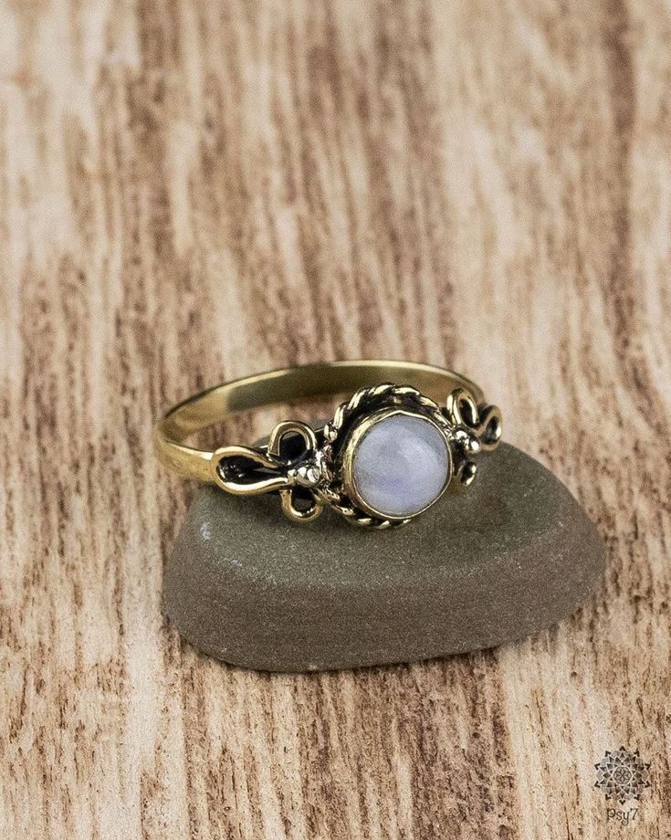 Filigree worked brass ring with embedded Moonstone. The setting of the gemstone is open towards the finger.  Material: brass - nickel & cadmium free Semi-precious stone: Moonstone Produced under fair conditions in India  To avoid disappointment, please note that colors and contrasts may look different depending on which monitor the photos are viewed on.   How do I determine my ring size?  The easiest way is to place a ring that fits you on a ruler and determine the inner diameter. Multiply this Gold Rings With Gemstone In Brass, Gold Moon-shaped Moonstone Ring Gift, Gold Opal Ring Adjustable, Gold Moon Shaped Moonstone Ring Gift, Gold Moonstone Ring With Moon Phase, Adjustable Gold Opal Ring, Gold Moonstone Ring Shaped Like Moon For Gift, Gold Adjustable Opal Ring, Round Shape, Adjustable Gold Crystal Ring With Moonstone