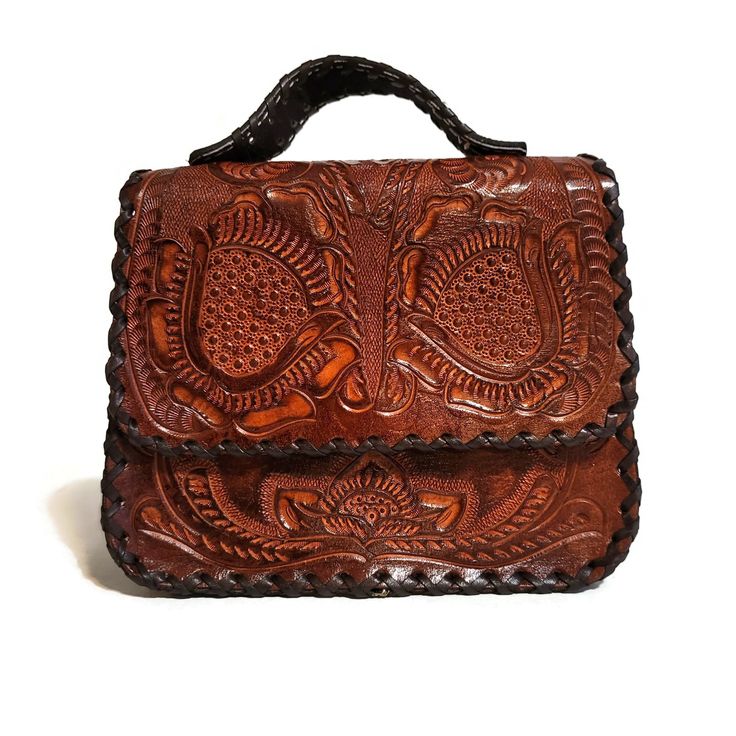 Crafted with meticulous attention to detail and a deep respect for traditional craftsmanship with a rustic touch that's hard to find in stores Gorgeous chiseled leather work. Genuine veg-tan leather that will last. Each bag is a one-of-a-kind work of art and requires patience, skill, and attention to detail. height: 14 cm. 5.5  inches width :19 cm.  7.5 inches base: 7cm.    3 inches color: honey  Large  adjustable and detachable strap:135 cm  53 inches interior: suede leather interior: 1 zipper Bohemian Hand Tooled Saddle Bag, Traditional Brown Satchel, Artisan Brown Shoulder Bag For Gift, Handmade Artisan Brown Saddle Bag, Western Style Satchel Bag For Travel, Artisan Handmade Brown Saddle Bag, Artisan Brown Handmade Saddle Bag, Traditional Brown Satchel Bag, Artisan Satchel Shoulder Bag With Hand Tooled Details