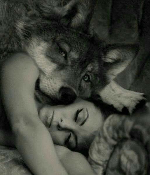 a woman laying next to a wolf on top of a bed with the caption, i'll be your dream catcher shadow keeper so you can sleep a little deeper