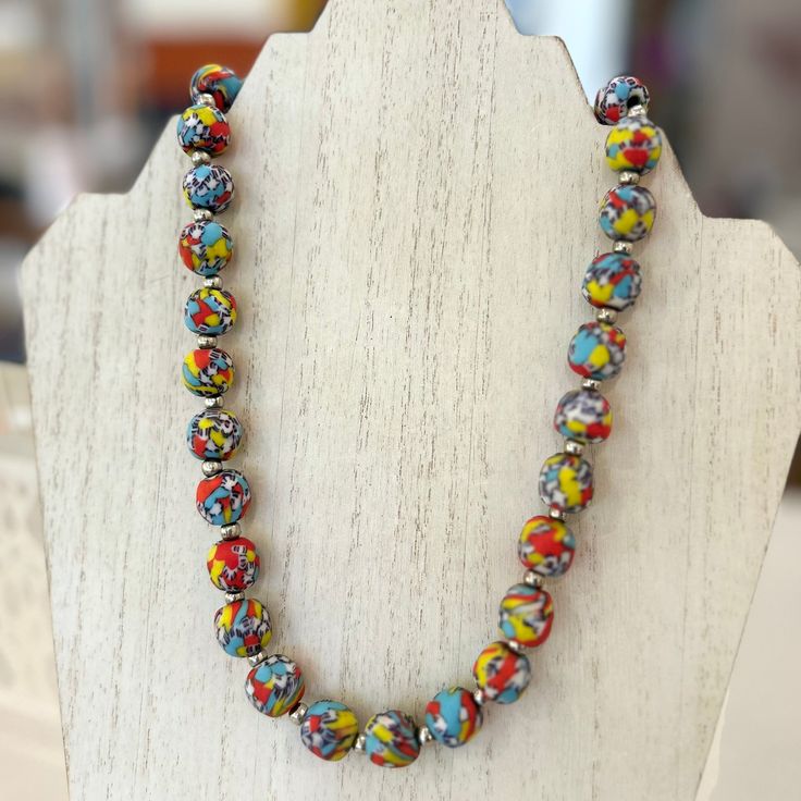 Embolden any outfit with this vibrant beaded necklace from Ghana. Called Krobo beads, these beautiful baubles are crafted from repurposed glass bottles that have been crushed into fine powder. Once the glass is transformed into powder, it is carefully poured into ceramic molds and then heated in a mud kiln oven. Born from a centuries old crafting traditional, each bead is completely unique, and no two necklaces are alike. Product Specifications: Glass beads and silver spacers Class closure Appro Multicolor Recycled Glass Bead Jewelry, Multicolor Recycled Glass Beaded Jewelry, Multicolor Recycled Glass Beads For Jewelry Making, Colorful Beaded Necklace Of Recycled Glass For Gifts, Multicolor Recycled Glass Jewelry For Jewelry Making, Colorful Recycled Glass Beaded Necklace As Gift, Multicolor Polished Czech Glass Necklaces, Colorful Beads Necklace For Jewelry Making, Colorful Recycled Glass Beads Necklace For Jewelry Making