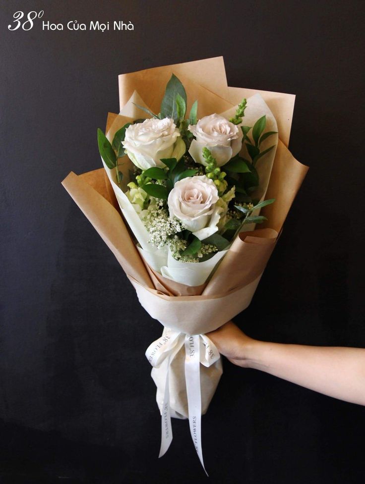 a person holding a bouquet of flowers in their hand