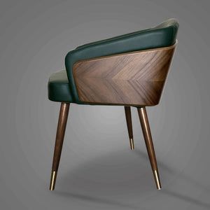 a wooden chair with green leather upholstered on the back and gold metal legs