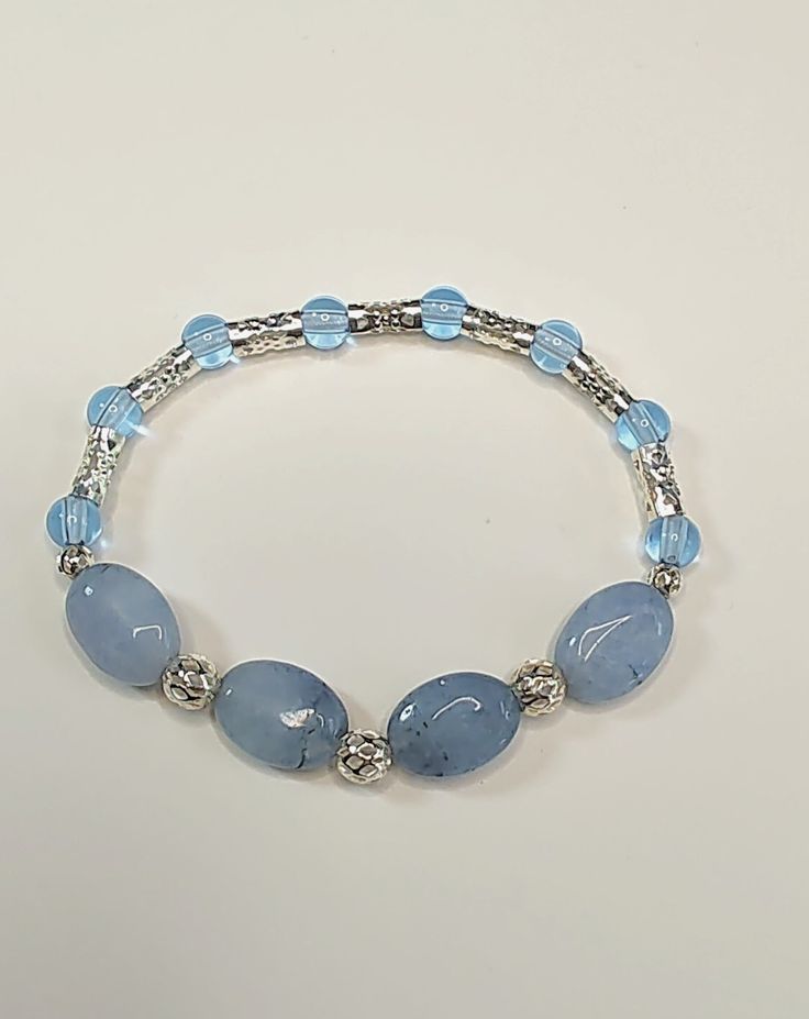 This pretty blue stone and bead bracelet is made on a stretchy, cotton-wrapped cord allowing for easy on and off. To see more handmade items and original art please visit my shop. Any questions or concerns feel free to contact me. Thank you, Amy Casual Blue Stretch Bracelet With Gemstone Beads, Light Blue Stretch Bracelet With Round Beads For Gift, Light Blue Stretch Bracelet With Round Beads, Light Blue Round Beads Stretch Bracelet For Gift, Handmade Light Blue Adjustable Beaded Bracelets, Handmade Adjustable Light Blue Beaded Bracelets, Adjustable Handmade Light Blue Beaded Bracelets, Adjustable Light Blue Crystal Bracelet, Blue Natural Stone Bracelets For Friendship