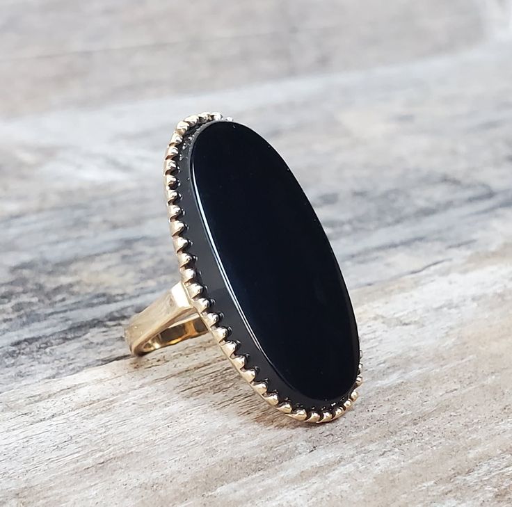 Vintage 10K Black Onyx Ring. Beautiful large black onyx. It is a gorgeous ring! Size 5 1/2 Weights 7.4g Black Onyx measures 1.1in x 0.6in Marked 10K This is an estate item that was pre owned and loved by others. It is in good vintage condition with minor wears from age and use. Please note all listing pictures are close up to show details of the item. Please look at the measurements and pictures before purchasing. Thank you for visiting! Vintage Onyx Ring, Cats Eye Ring, Marcasite Ring, Masonic Ring, Gorgeous Ring, Black Onyx Ring, Sapphire Pendant, Tiny Diamond, Eye Ring