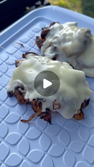 two pieces of food sitting on top of a plastic tray covered in white icing