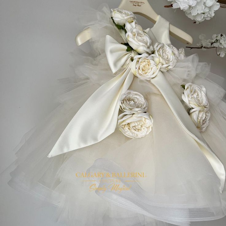 Lilly roses ballgown in color Vanilla From first birthday dresses to flower girl dresses, every kid deserves to look like a princess on their special day. That's why Kids Couture has the perfect custom made lilly dress in color vanilla for you! The handmade designs feature a tulle ruffle floor length dress and with delicate tones of ivory and sparks of glitter, no moment is more stunning than your first birthday or baptism. It's the perfect first birthday or christening dress for girls that will Big Bow Dress, Ivory Flower Girl Dress, First Birthday Dresses, Ivory Flower Girl, Couture Looks, Baby Couture, Girls Couture, Ivory Roses, Christening Dress