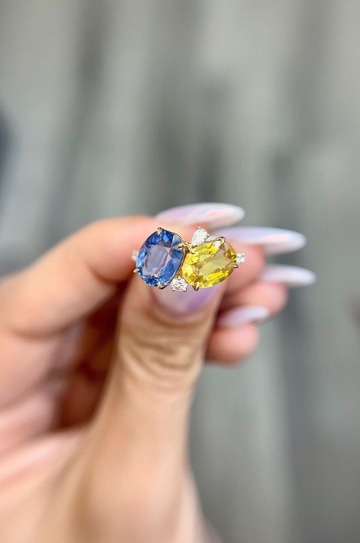 "DETAILS: * Handmade item * Gemstone: Diamond, Sapphire * Gem Size in Pictures: Sapphires Blue, Yellow 4.5 CTW Option * Band color: 14k Yellow Gold (may vary on gold selection) * Condition: Never been Used; Made to order, Recycled Metal, Conflict-free 100% DESCRIPTION: 💎 Welcome to the Our Shop, Congratulations🍾 on discovering us. 💎 The ring is a stunning piece with intricate detailing and unique piece. It features a blue and yellow oval sapphire set in 14k, one round and one pear diamond on Yellow Sapphire And Diamond Ring, Two Stone Sapphire Ring, Gold Oval Sapphire Ring With Multi-stones, Gold Multi-stone Sapphire Ring With Oval Shape, Gold Multi-stone Oval Sapphire Ring, Oval Sapphire Gemstone With Multi-stone Detail, Oval Multi-stone Sapphire Gemstones, Fine Yellow Oval Sapphire Ring, Oval Sapphire Multi-stone Gemstones