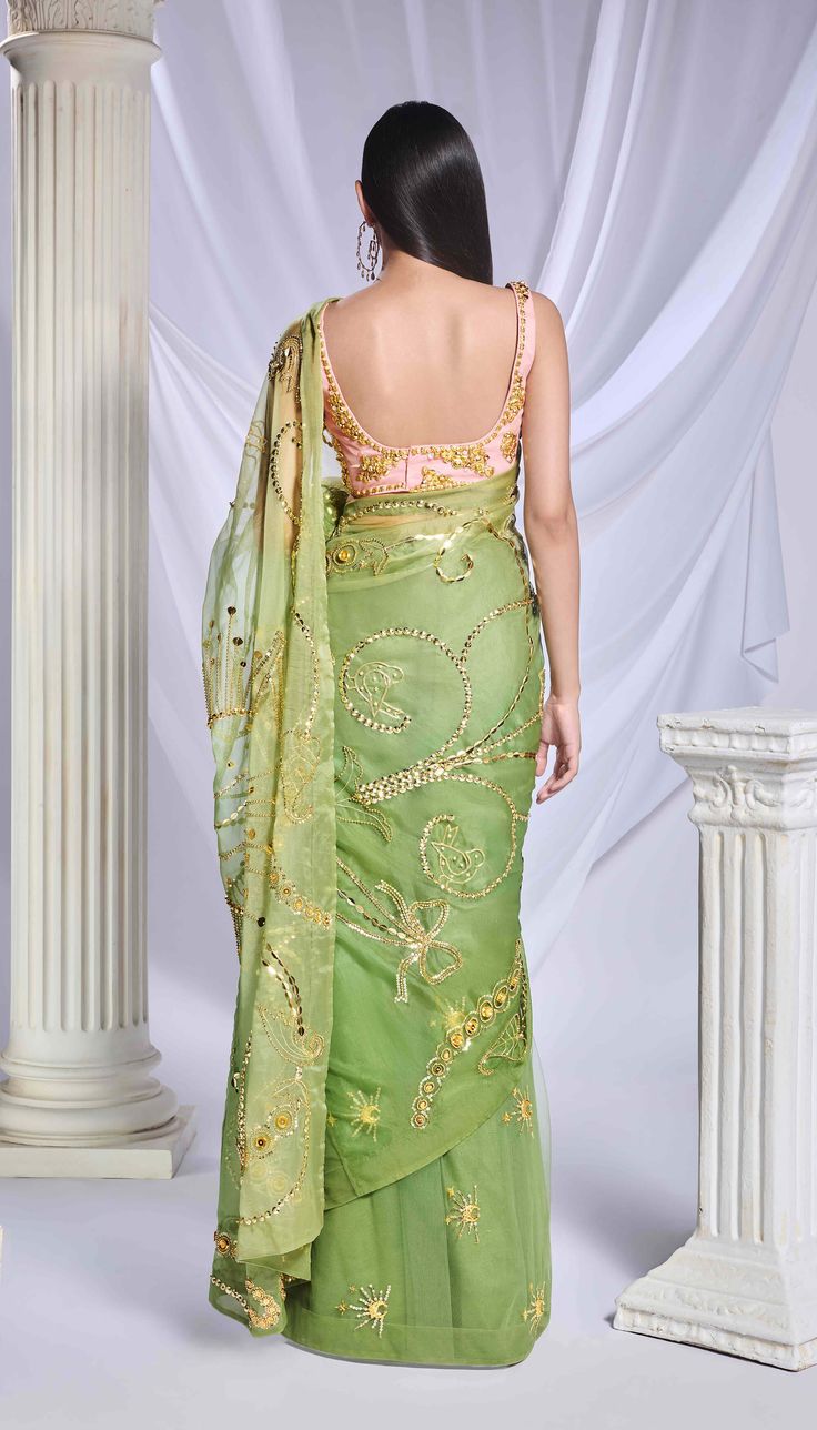 Introducing our moss green shaded sari, skillfully crafted from a blend of organza and tulle. The organza pallu is adorned with intricate gold embroidery, incorporating sequins, cut dana detailing, and gold metallics that narrate a charming tale with elements like flowers, butterflies, and hearts. The pre-stitched tulle bottom features scattered detailing with motifs of moons and stars. Completing the ensemble is a rose pink blouse featuring a straight neckline, adorned with elaborate golden chu Orange Organza Saree, Chunky Embroidery, Engagement Sarees, Papa Don't Preach, Reception Sarees, Green Sari, Haldi Dress, Tulle Blouse, Celebrity Closet